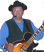 Roger Chartier wtih blue shirt and guitar