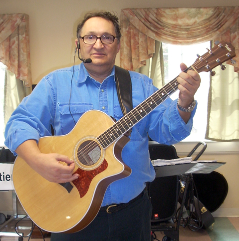 Roger Chartier plays a Taylor guitar